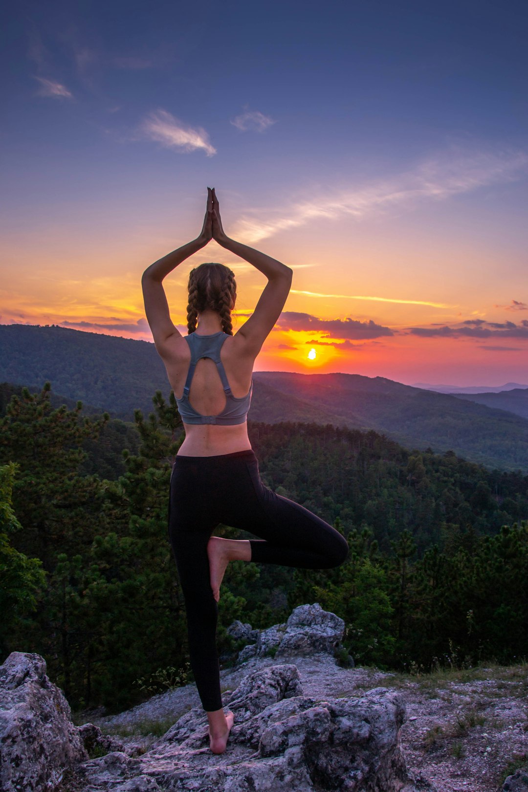 woman-in-black-leggings-standing-on-rock-formation-during-sunset-cxnglqf7xdo